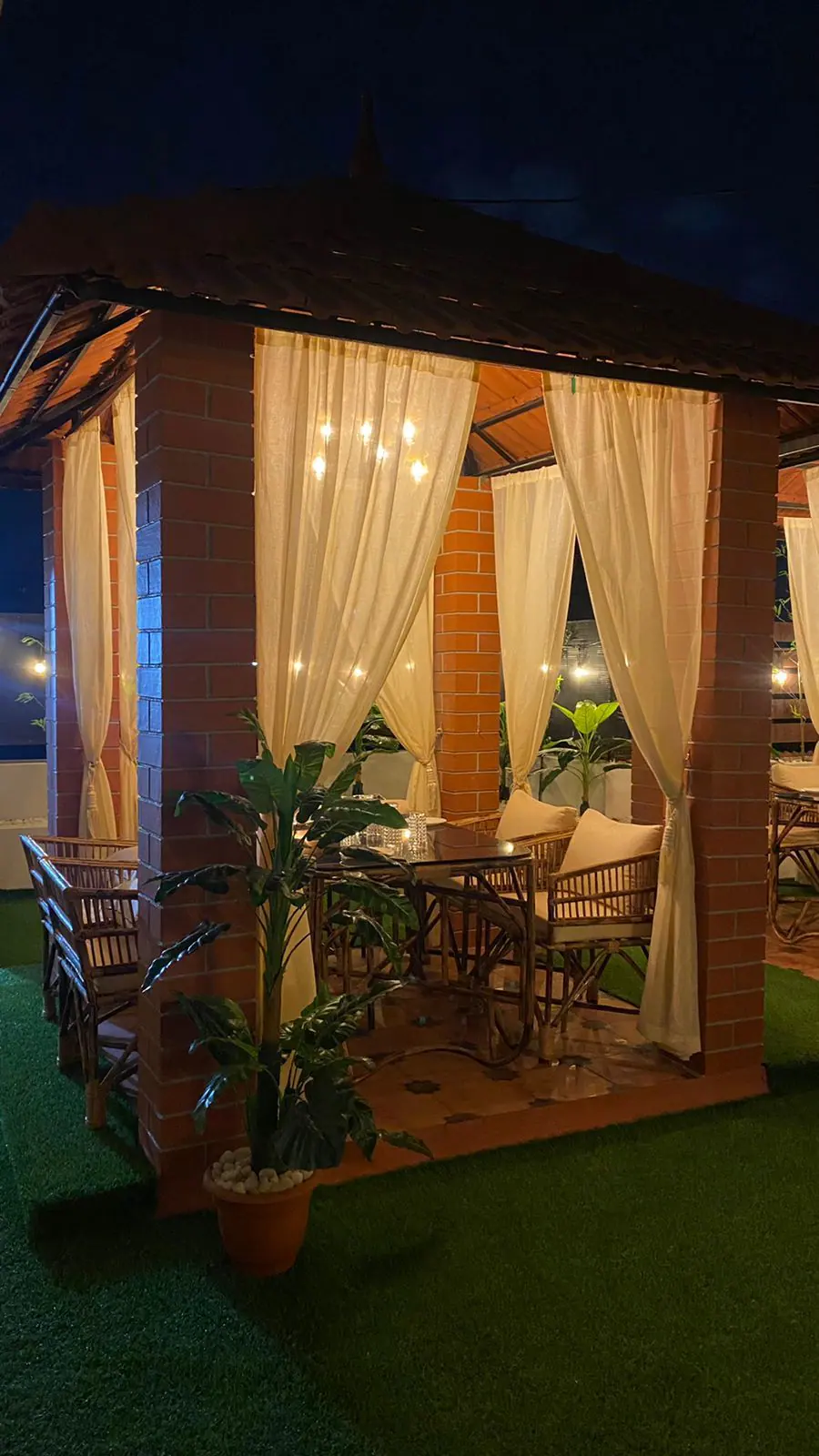 Viraasat rooftop — candlelit gazebo at night, Vepery Chennai